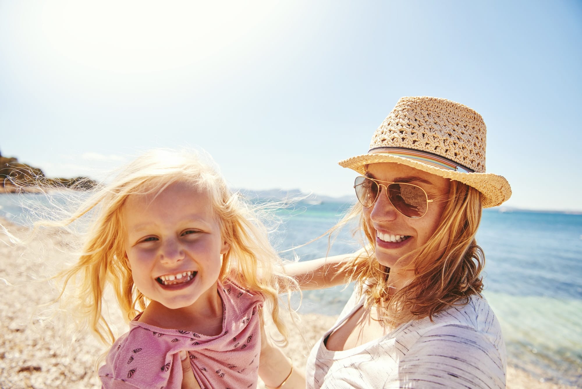 Happy mother and daughter at the beach