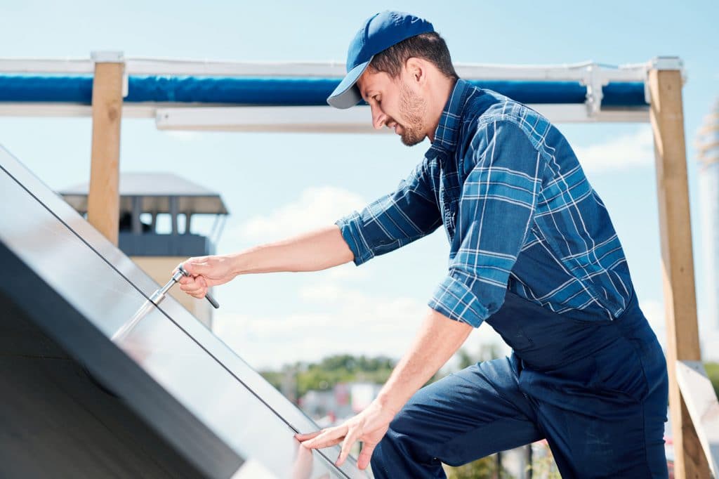 Young contemporary technician of customer service repairing handle