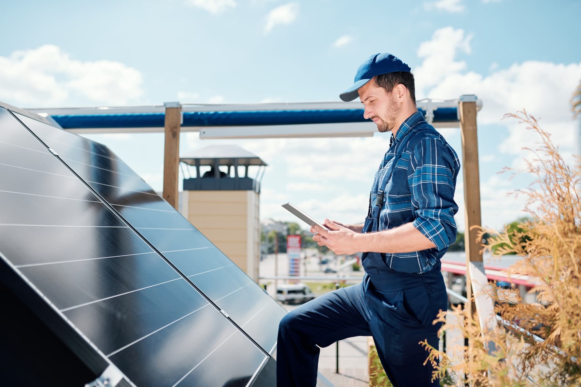 Young master with tablet searching for online data about solar panels