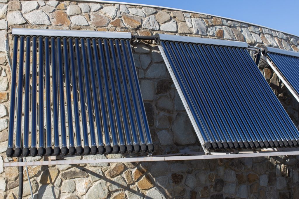 Solar water heating system installed on wall or roof of house.