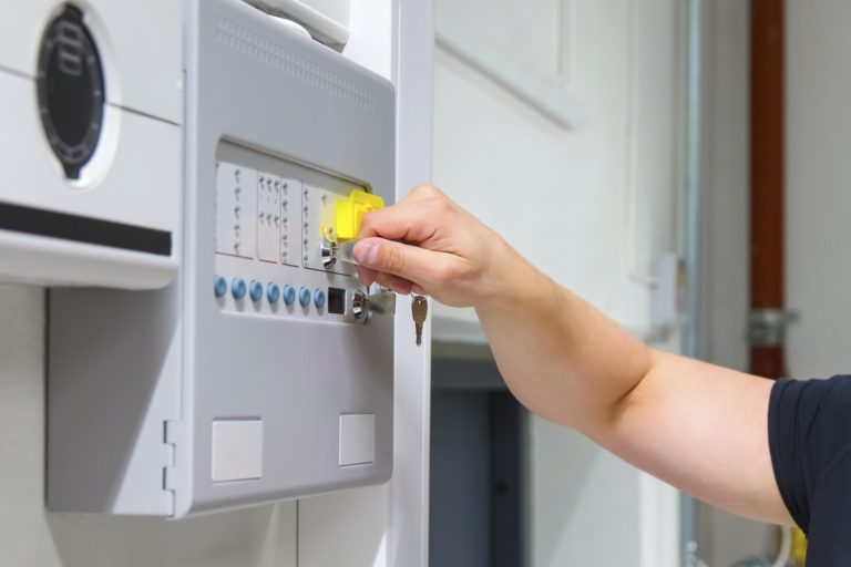 Close-up of Service Technician Opening Fire Panel In Server Room