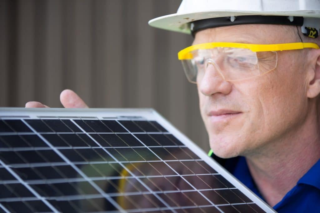 Technician worker working on solar cell installation at sit.